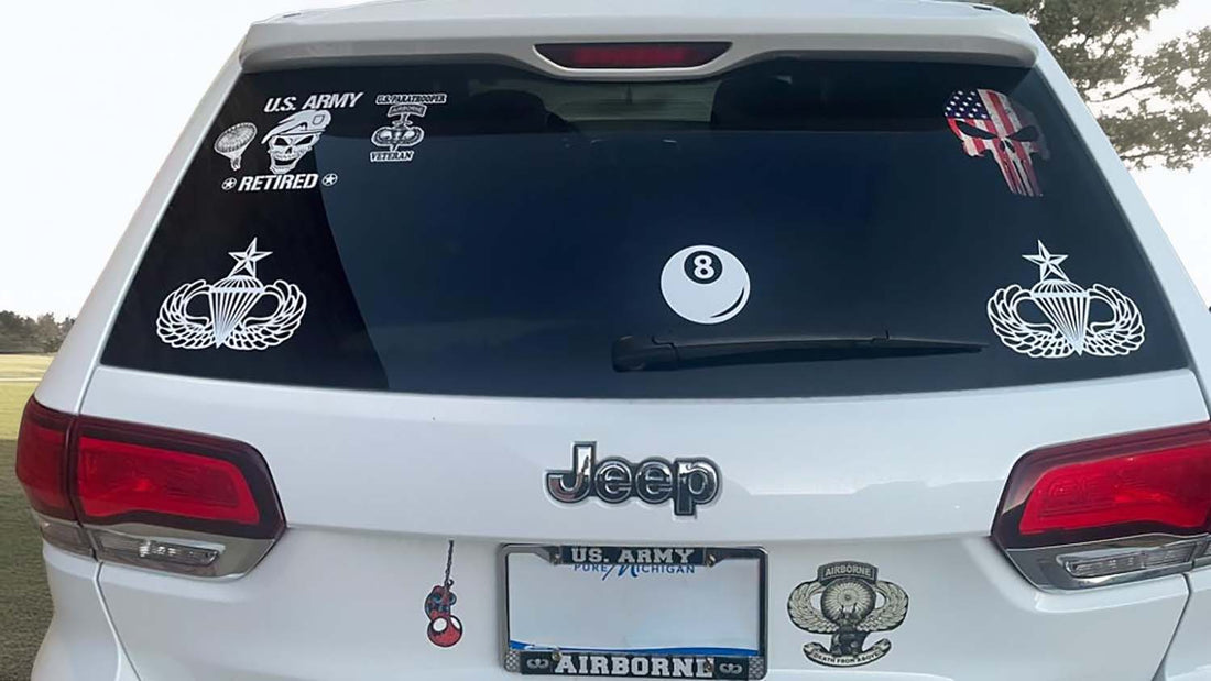 Military stickers and decals on a Jeep Wrangler, organized by service branch