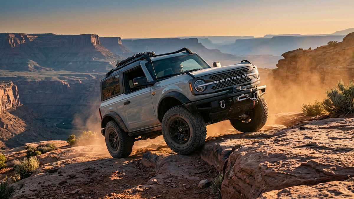 Ford Bronco on a rocky off-road trail with mountains behind it, illustrating a bucket list of the best Bronco trails