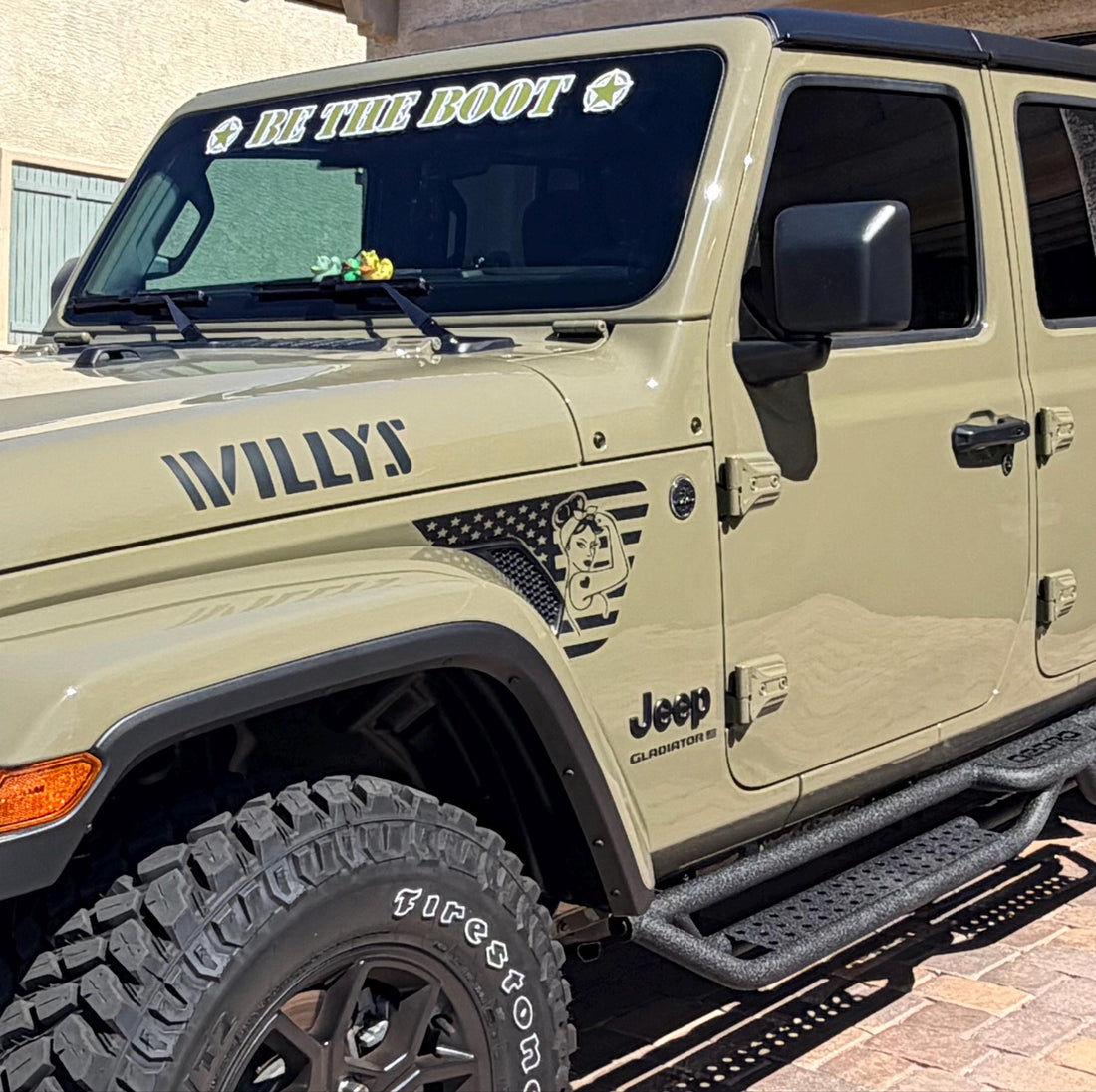 Sarge Green Jeep Gladiator Willys Edition with Rosie the Riveter American flag fender vent decal, Willys hood lettering, and Be The Boot windshield banner