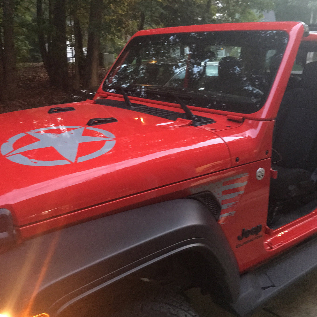 Firecracker Red Jeep with a custom edition hood decal on the trail