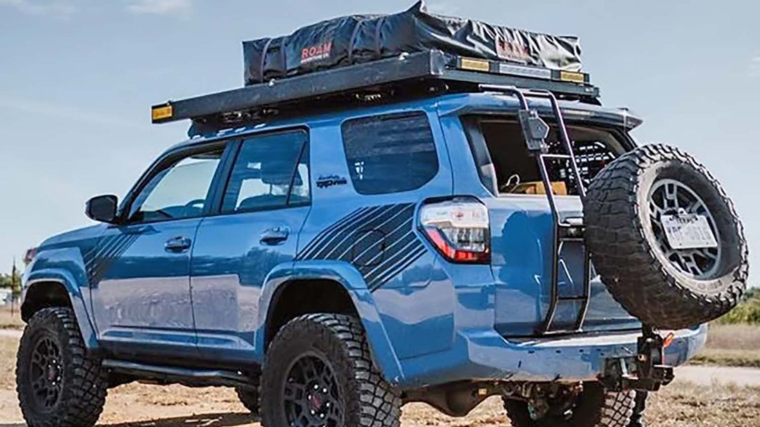 Full-size spare tire mounted on a swing-out hitch carrier on the back of a Toyota 4Runner