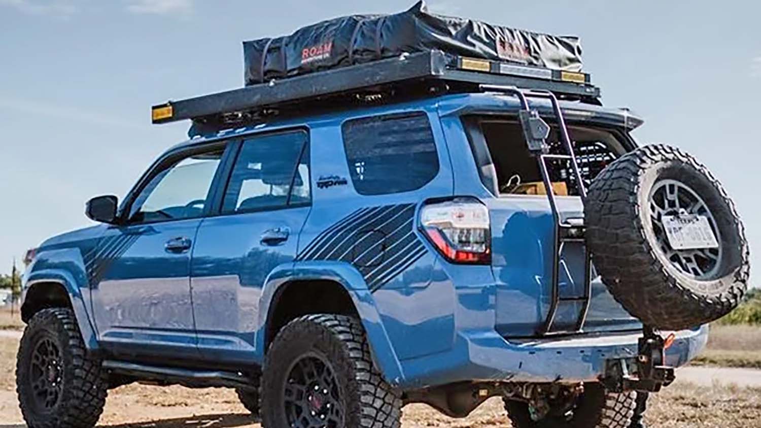 Full-size spare tire mounted on a swing-out hitch carrier on the back of a Toyota 4Runner