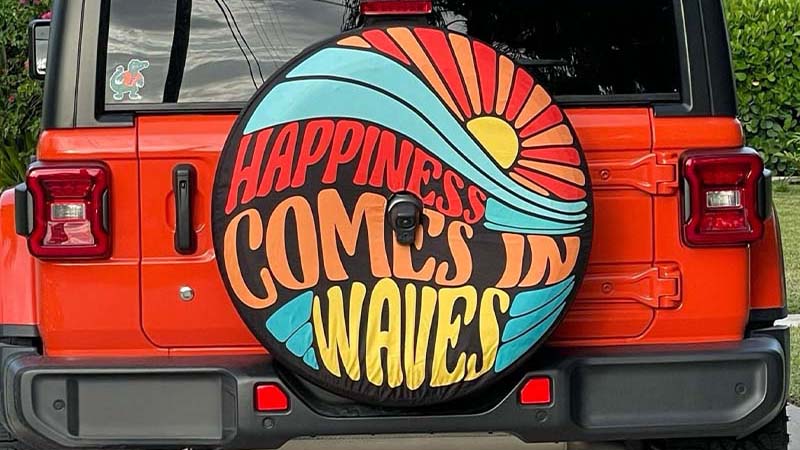 Spare tire cover on a Jeep JL Wrangler tailgate with custom graphic design