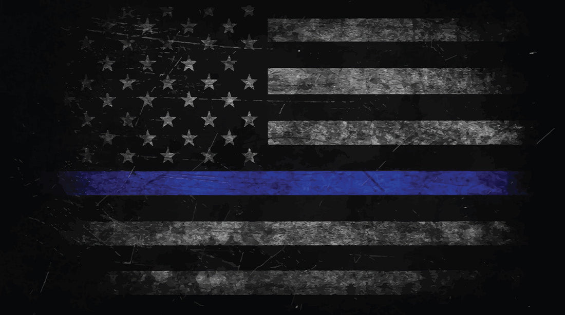 A black and white American flag decal with a single blue stripe applied to a vehicle's rear quarter window