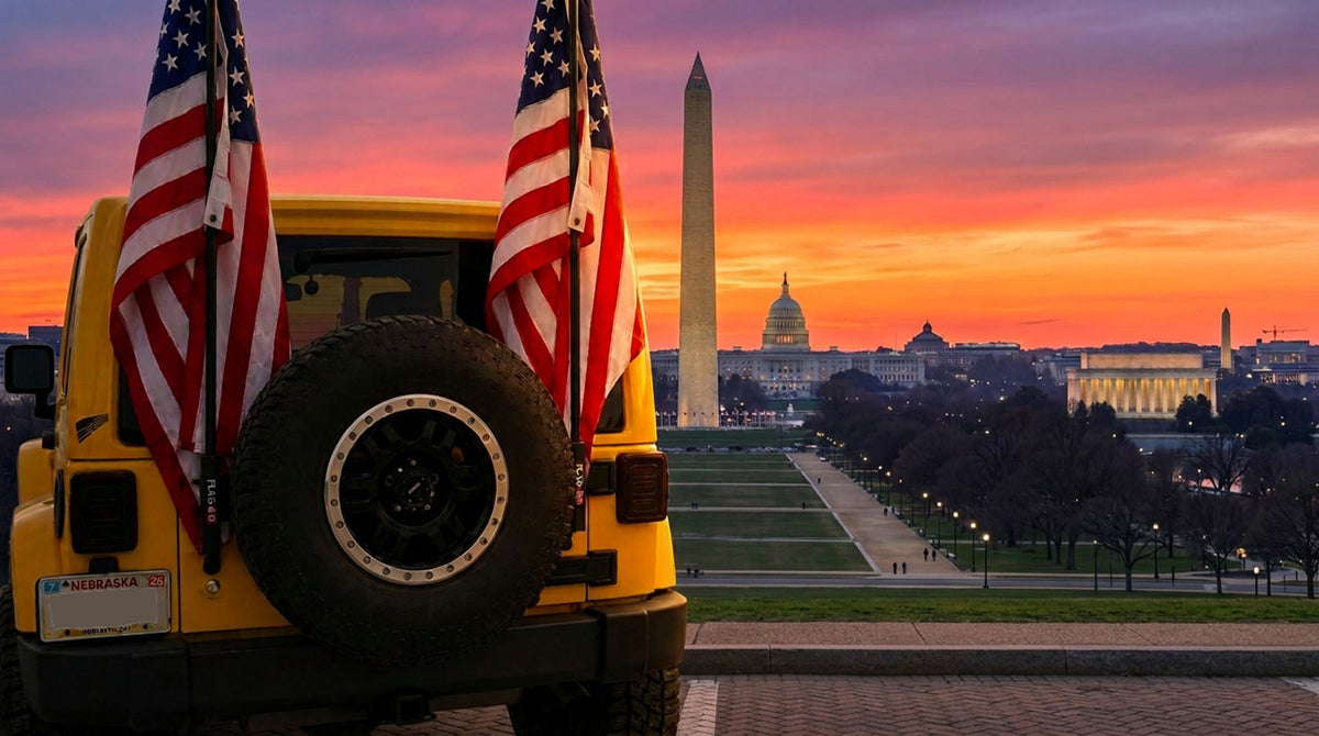 Yellow Jeep Wrangler with two American flags on rear flag poles at sunset, parked above the National Mall with the Washington Monument, the U.S. Capitol and the Lincoln Memorial in the distance
