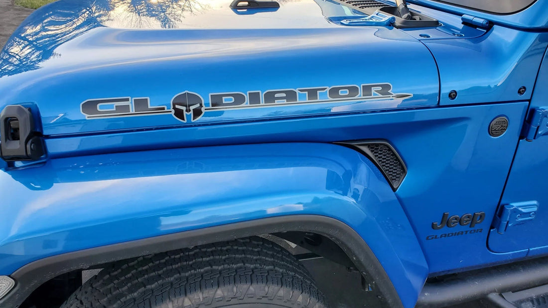 Hydro Blue Jeep Gladiator with a side hood decal on the trail