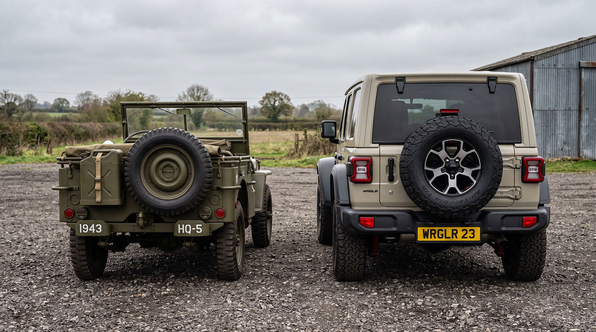A WWII Willys MB and a modern Jeep Wrangler photographed from the rear, both carrying a full-size spare tire mounted on the tailgate