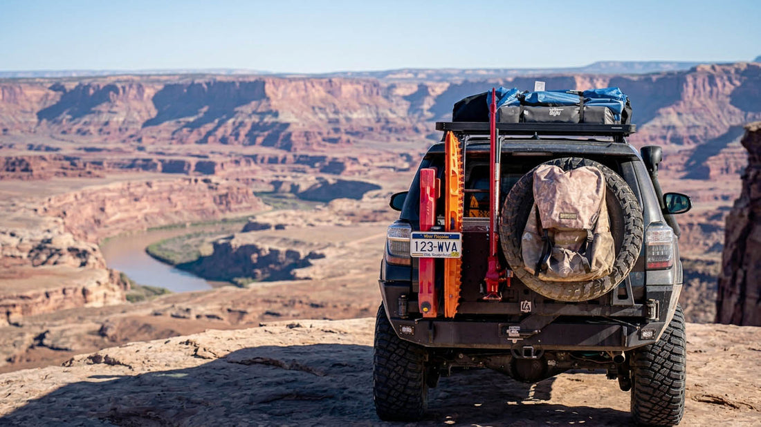An overland vehicle showing external spare tire mounting options, a tailgate mount and hitch carrier, with a spare tire cover