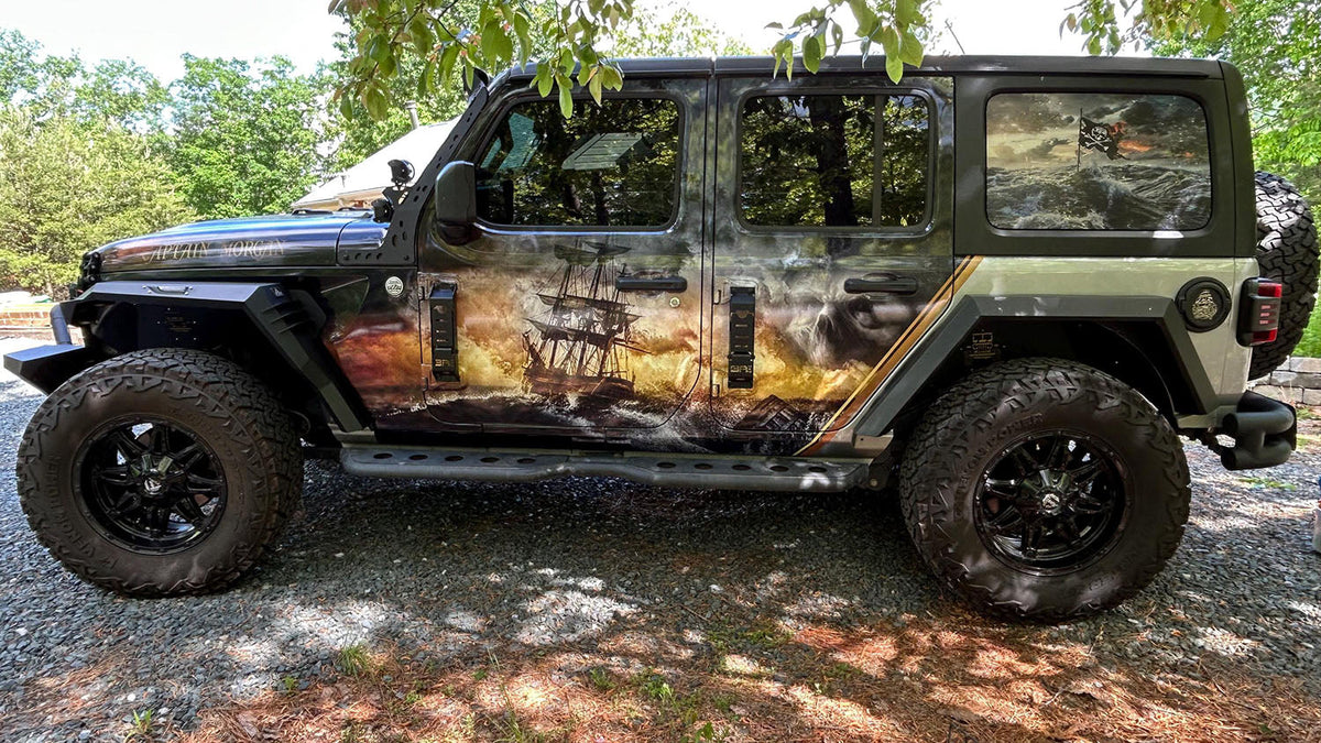 Jeep Wrangler with a full-color printed pirate ship graphic wrap and laminate coating on the hood and fender