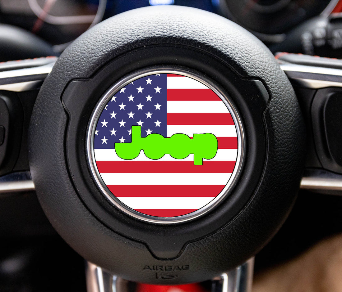 Round American flag steering wheel horn-pad overlay, a laminated printed graphic, installed on a Jeep Wrangler airbag cover