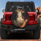 Heaven vs Hell Ultimate Battle spare tire cover on red Ford Bronco rear with sage facing fiery demon