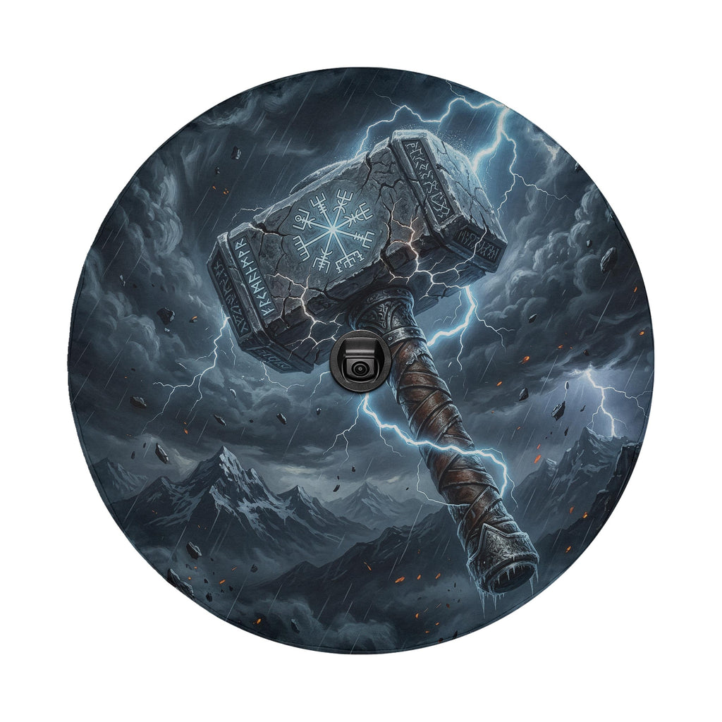 A large, imposing hammer with a lightning bolt symbol on it, surrounded by a stormy, mountainous landscape with lightning and rain.