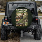 a black Jeep Wrangler with a large tire cover on the rear of the vehicle. The cover has an advertisement for soylent green, which is a product made of people.