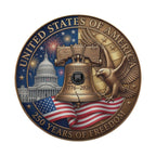 The image is a commemorative coin or badge celebrating the 250th anniversary of the United States of America. It features the iconic Liberty Bell, the United States Capitol building, and an eagle, all set against a backdrop of fireworks and the American flag.