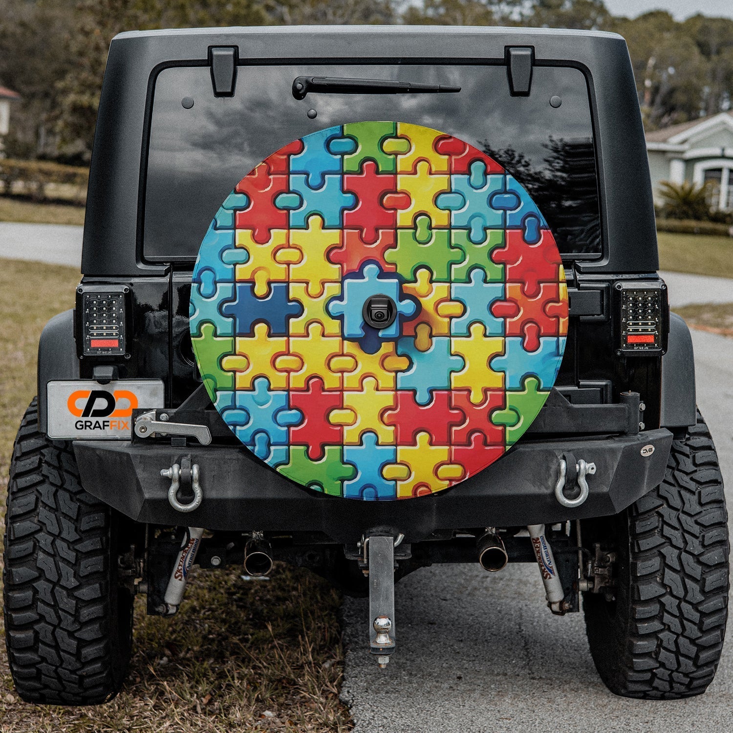 Spectrum of Unity spare tire cover on black Jeep Wrangler rear with rainbow puzzle piece spare cover