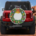 Red Ford Bronco rear displaying Christmas wreath spare tire cover with bells bow and bright ornaments