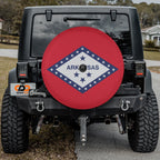 Arkansas state flag spare tire cover on red Jeep Wrangler with desert backdrop showing diamond and star design