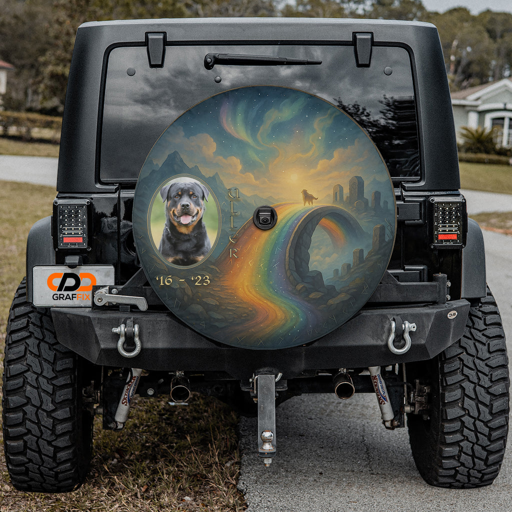 a black Jeep Wrangler with a large, colorful wheel cover depicting a rainbow and a dog.
