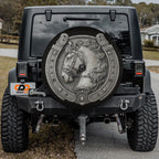 the rear of a black Jeep Wrangler with a large, decorative wheel cover featuring a horse's head and a horseshoe design.