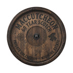 A wooden barrel with embossed text and a compass symbol, indicating it is a 60-year-old Maccutcheon Private Collection.