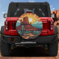 Sunset Over Sedona tire cover on a red Ford Bronco showing desert mesa cactus sunburst and turquoise sky