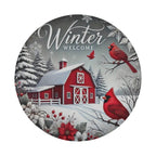 A red barn surrounded by snow and trees, with two red cardinals perched on branches nearby. The text "Winter Welcome" is displayed above the barn.