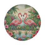 A pair of pink flamingos standing in a tropical garden, surrounded by lush foliage, flowers, and a body of water.