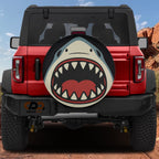 Shark Bite spare tire cover on red Ford Bronco with open jaws teeth cartoon shark design