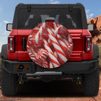 Peppermint Christmas candy cane spare tire cover on red Ford Bronco with red white striped candies