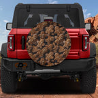Gingerbread cookies pattern spare tire cover on red Ford Bronco showing iced brown holiday cookies