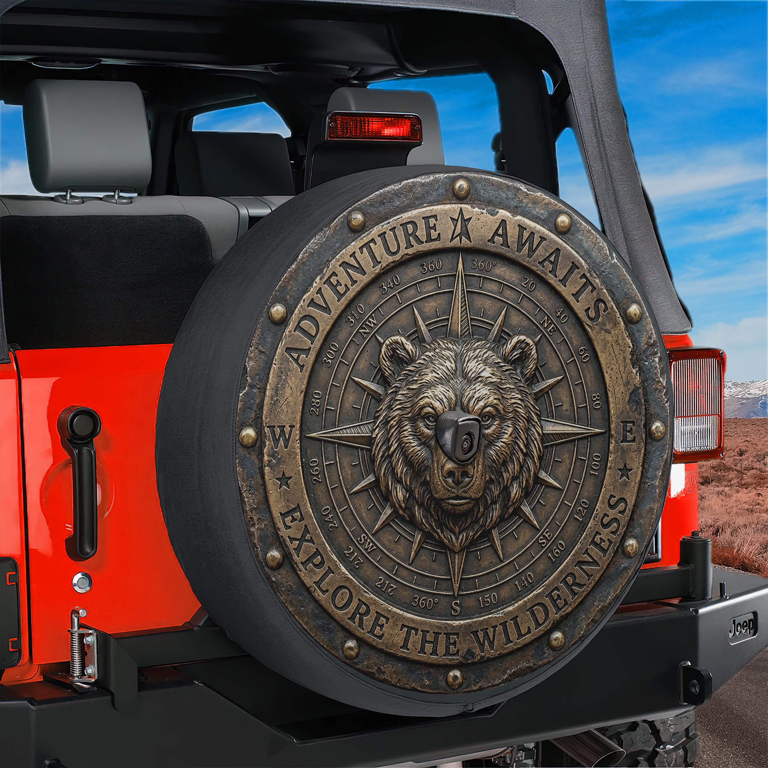 a red Jeep with a large, decorative spare tire cover on the back. The cover has a bear head design and the words "Adventure Awaits" and "Explore the Wilderness" written on it.