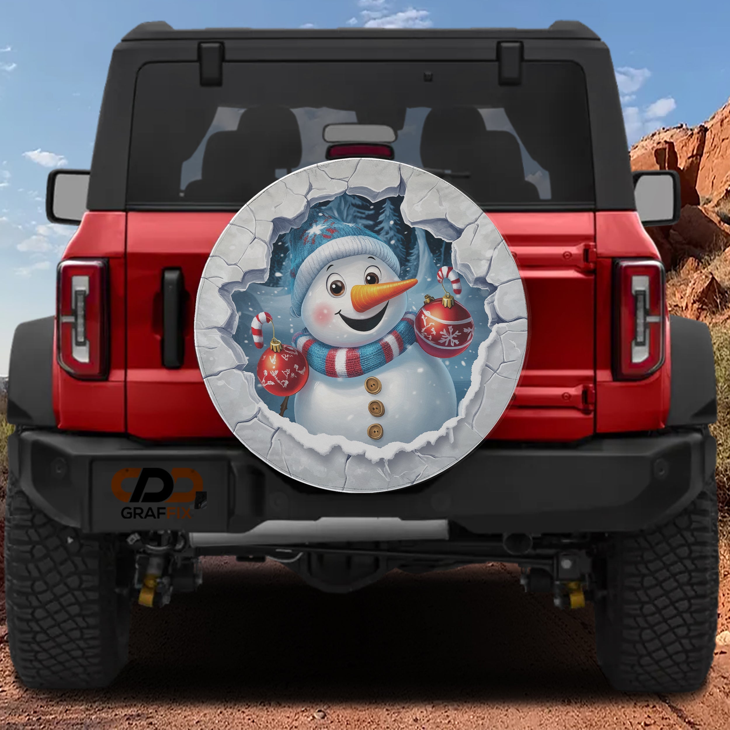 Frosty Snowman Ice Breaker spare tire cover on a red Jeep Wrangler with cheerful snowman art