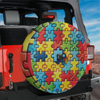 Spectrum of Unity spare tire cover on red Jeep Wrangler with bright autism awareness puzzle artwork