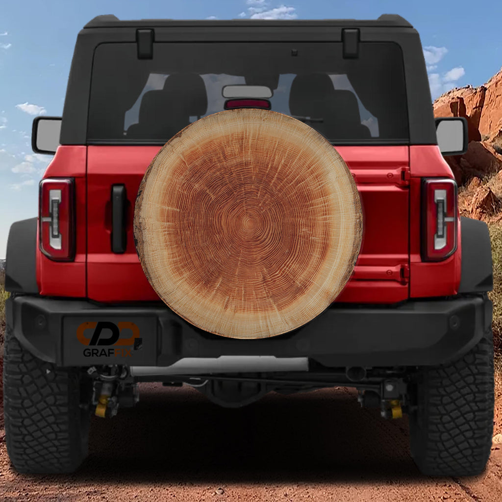 a red Jeep Wrangler with a large tree trunk mounted on the rear of the vehicle.