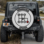 Endangered Species gear shift spare tire cover mounted on Jeep rear with desert backdrop