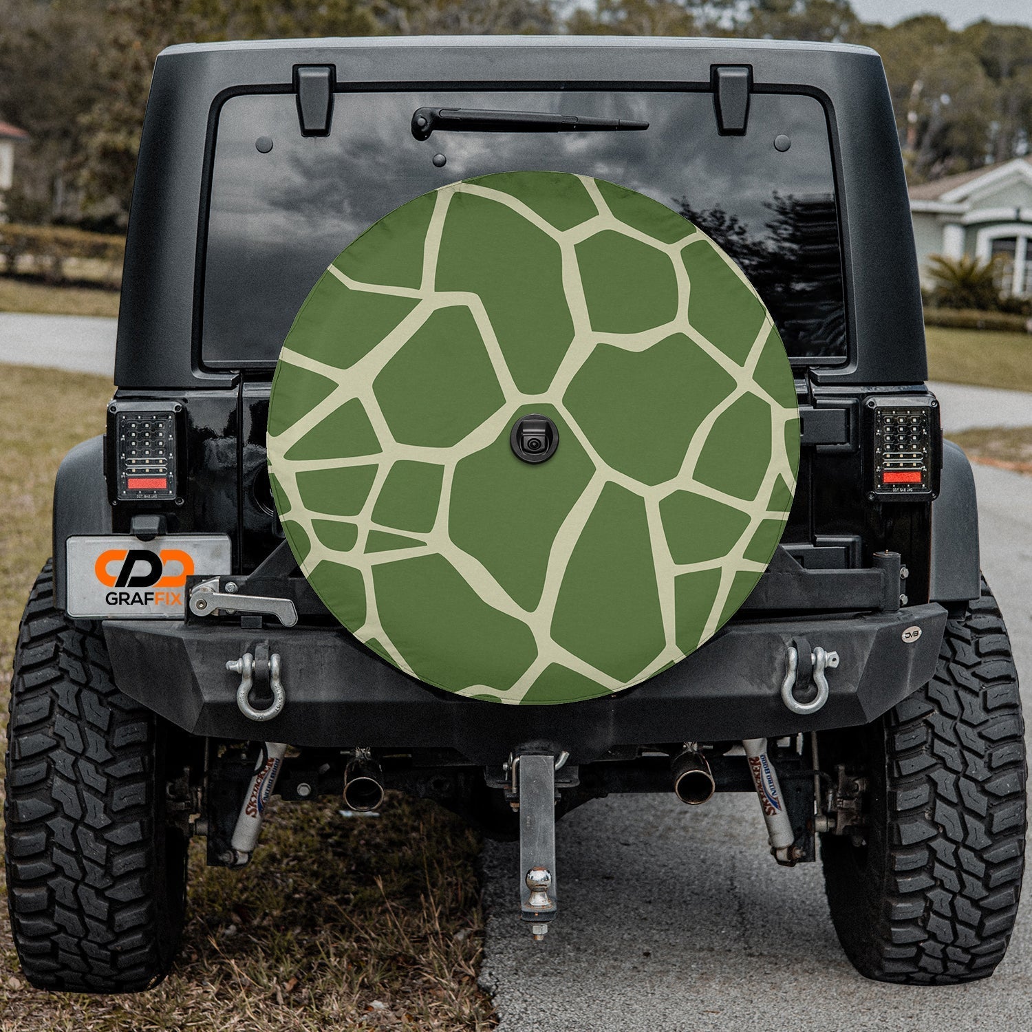 Turtle Trek spare tire cover on a black Jeep Wrangler rear hatch with the green turtle shell scute pattern art