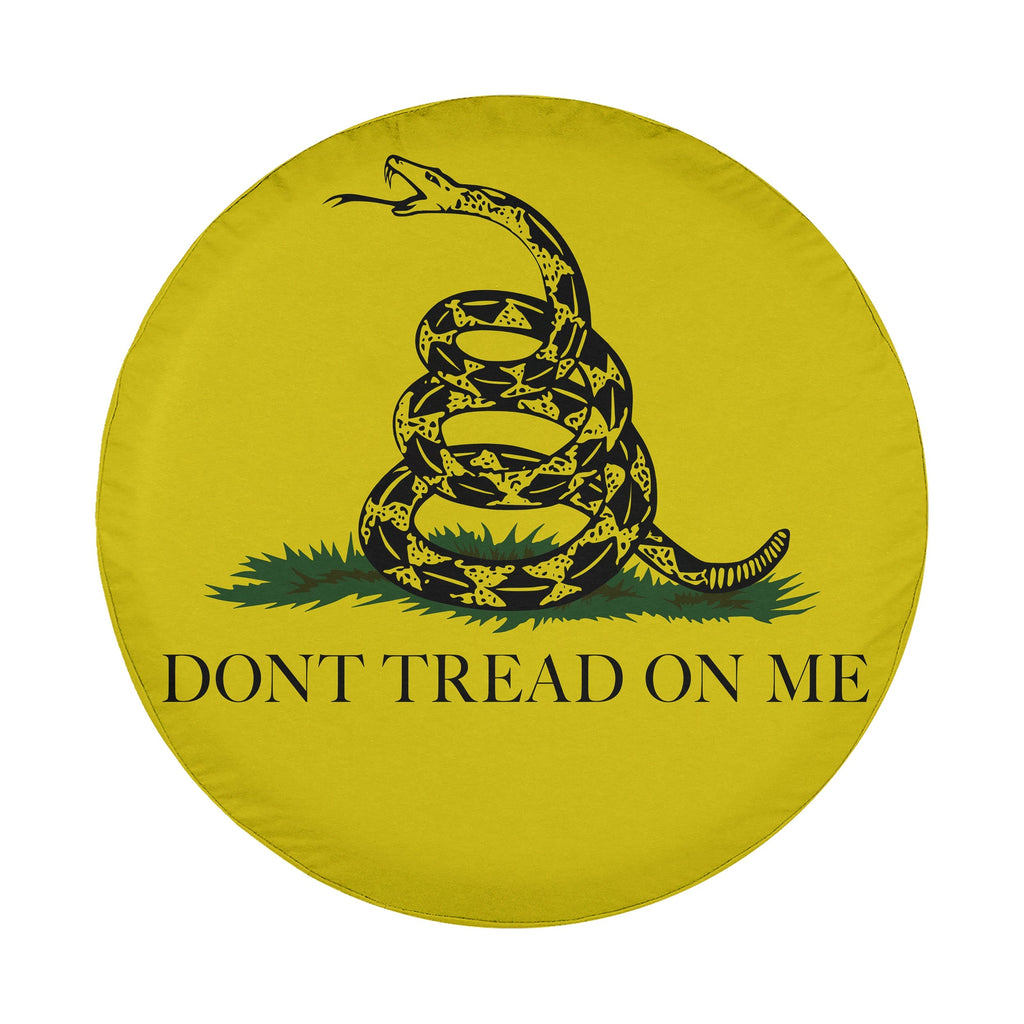 Gadsden flag tire cover flat round product view with coiled rattlesnake over grass on bright yellow field