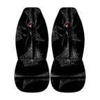 a pair of black car seat covers with a spider design on them.