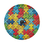 Spectrum of Unity spare tire cover detail showing autism puzzle pieces and central camera cutout