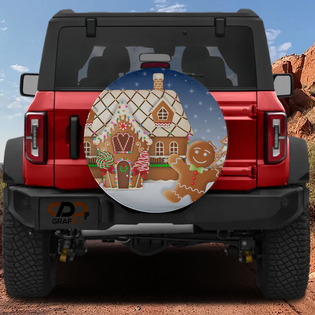 Red Bronco with gingerbread house spare tire cover featuring lollipops candy canes and snowy night sky
