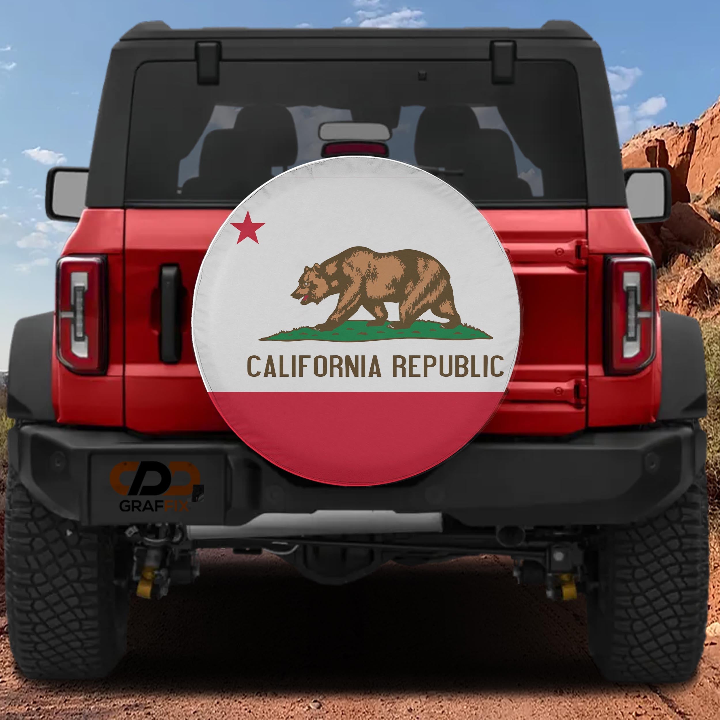 California Republic state flag spare tire cover mounted on red Ford Bronco rear with red rock canyon backdrop