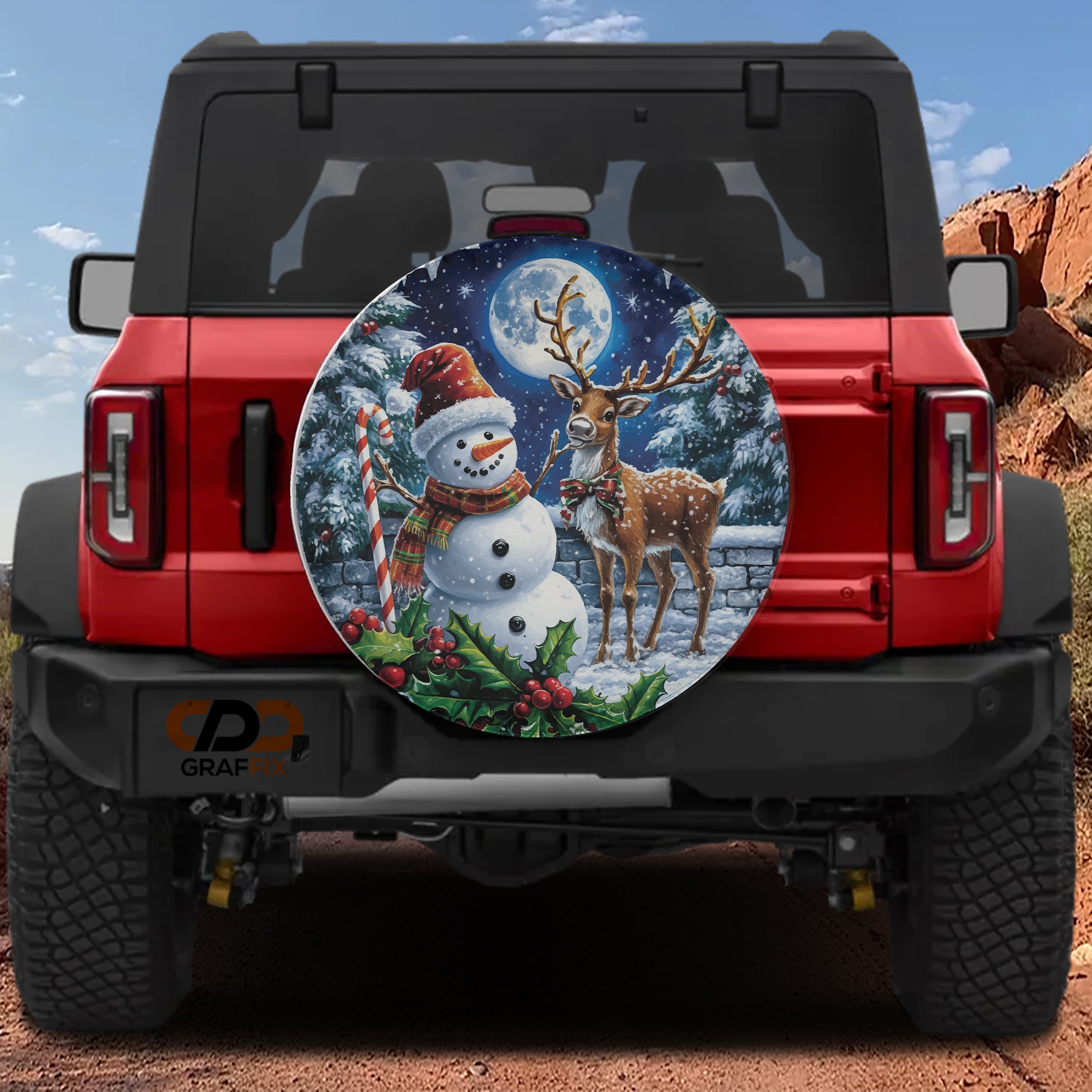 Jolly Snowman and Reindeer night spare tire cover mounted on a red Jeep Wrangler in snowy mountains