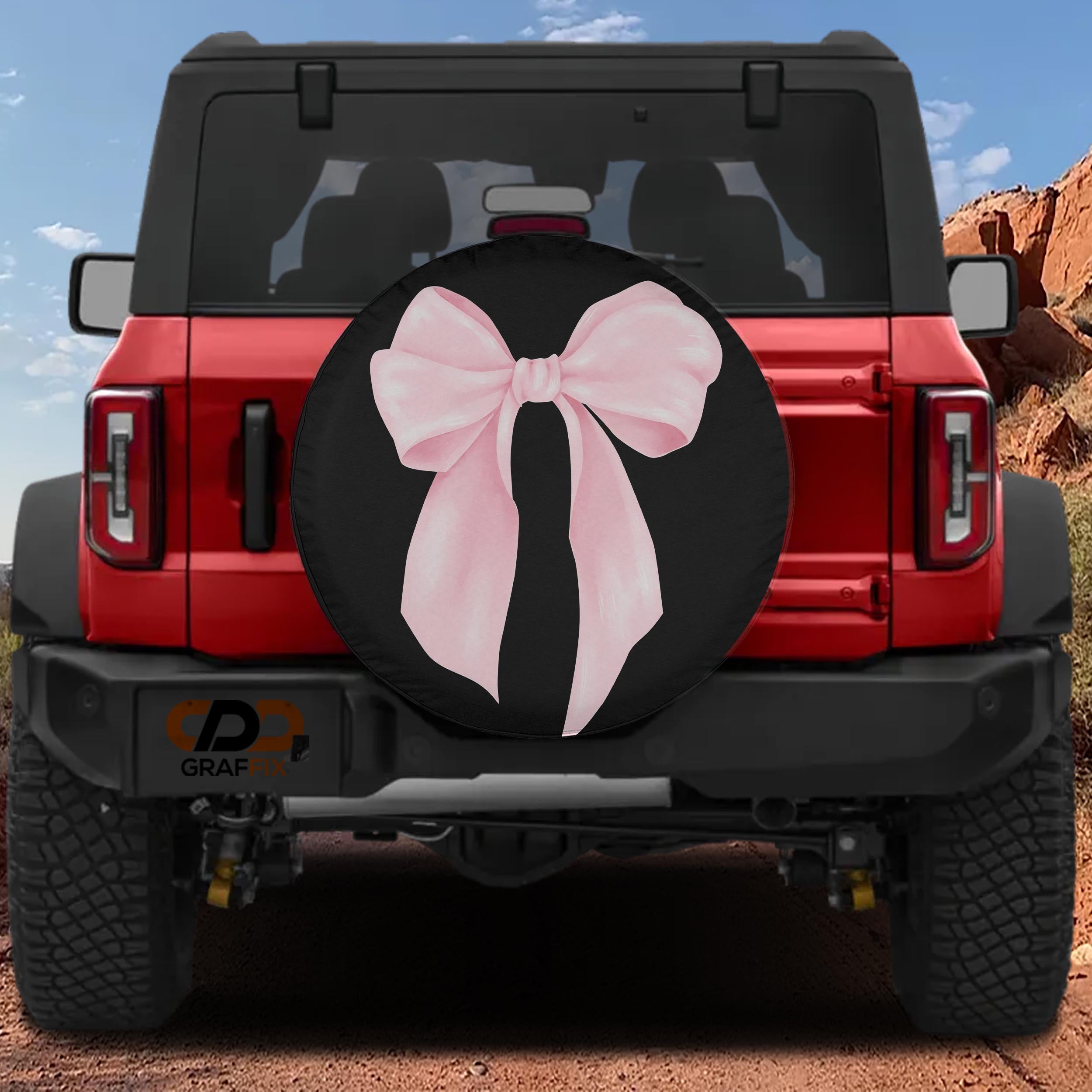 the rear of a red Jeep Wrangler with a large pink bow on the spare tire cover.