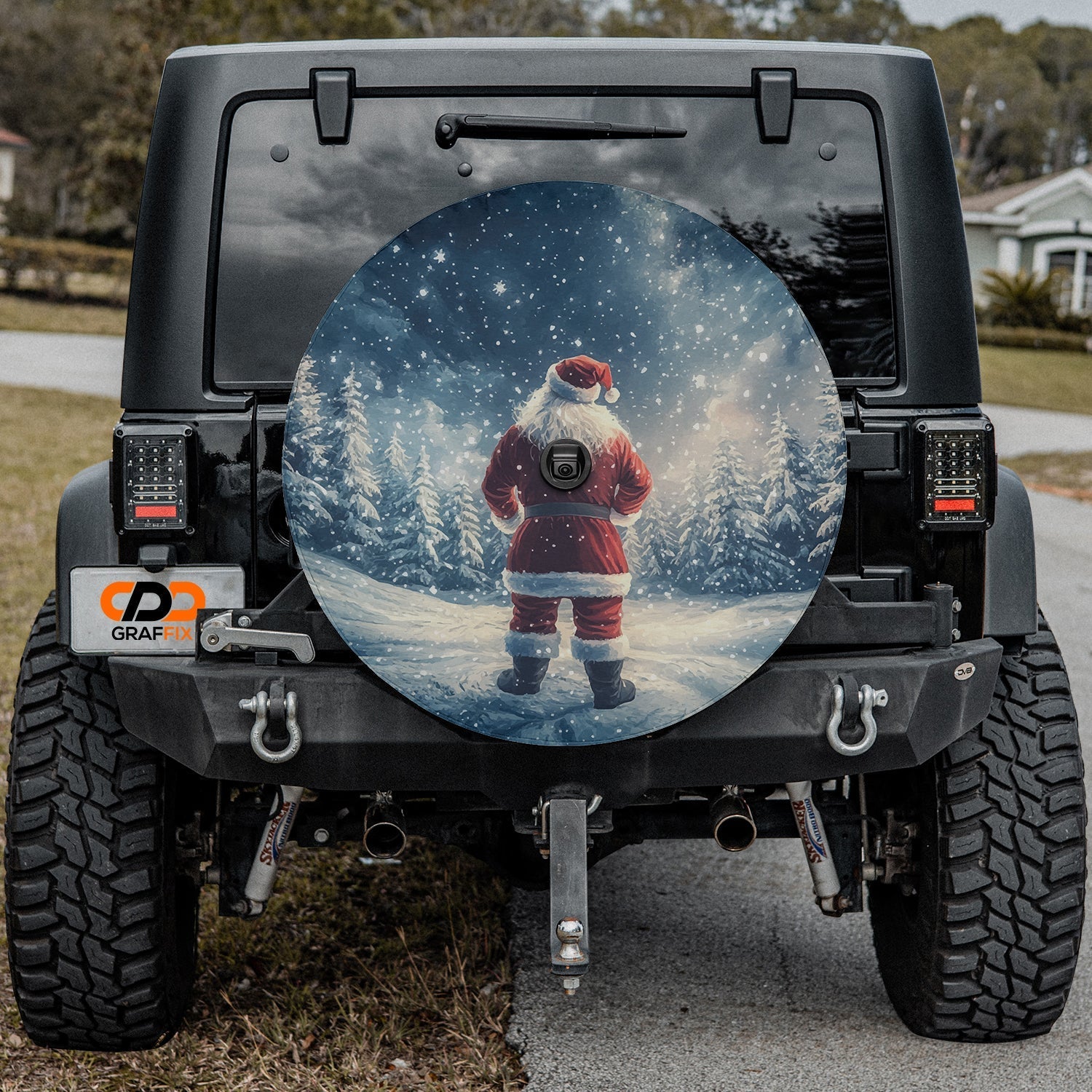 Festive Santa Claus winter wonderland spare tire cover installed on a Jeep Wrangler tailgate