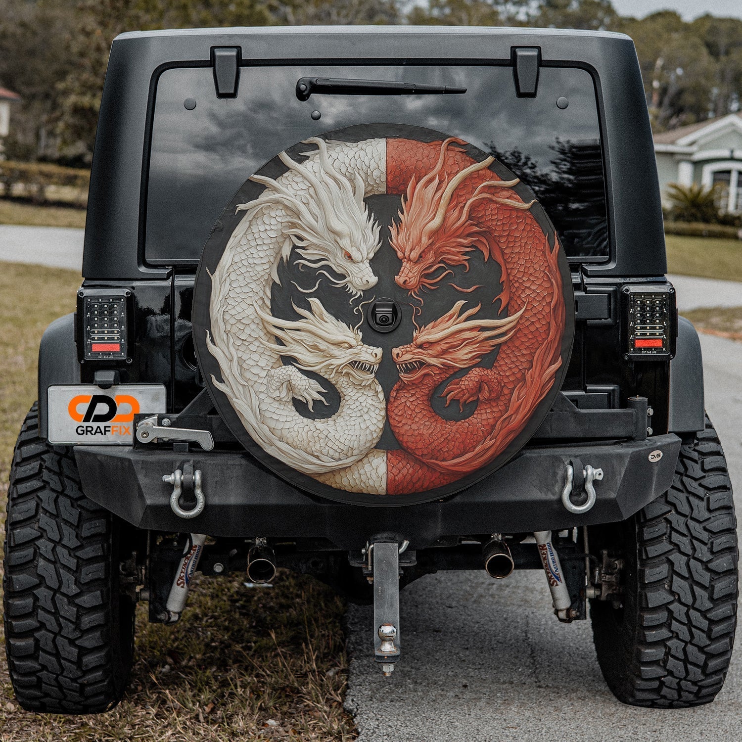 Balance of the Dragons spare tire cover on black Jeep Wrangler rear with carved twin dragons on tailgate