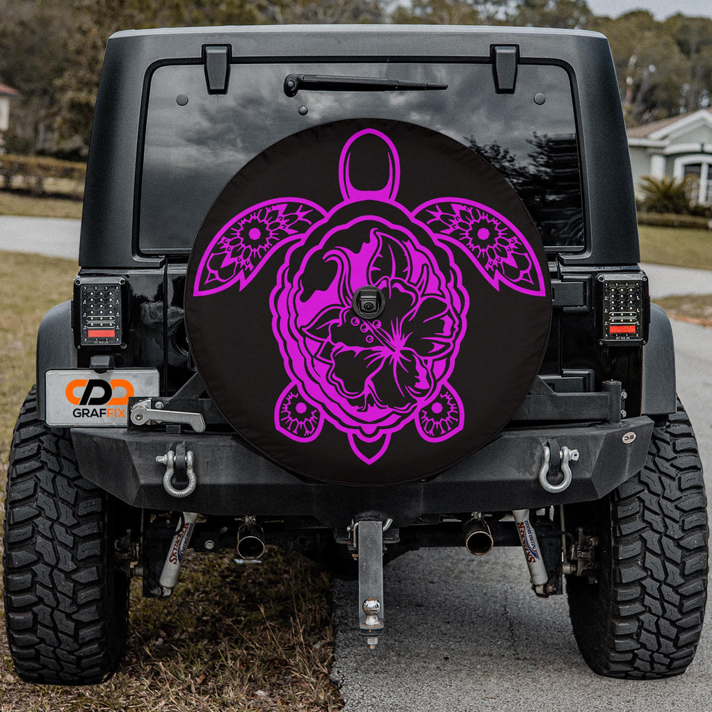 a black Jeep Wrangler with a large, decorative tire cover featuring a pink and purple floral design.