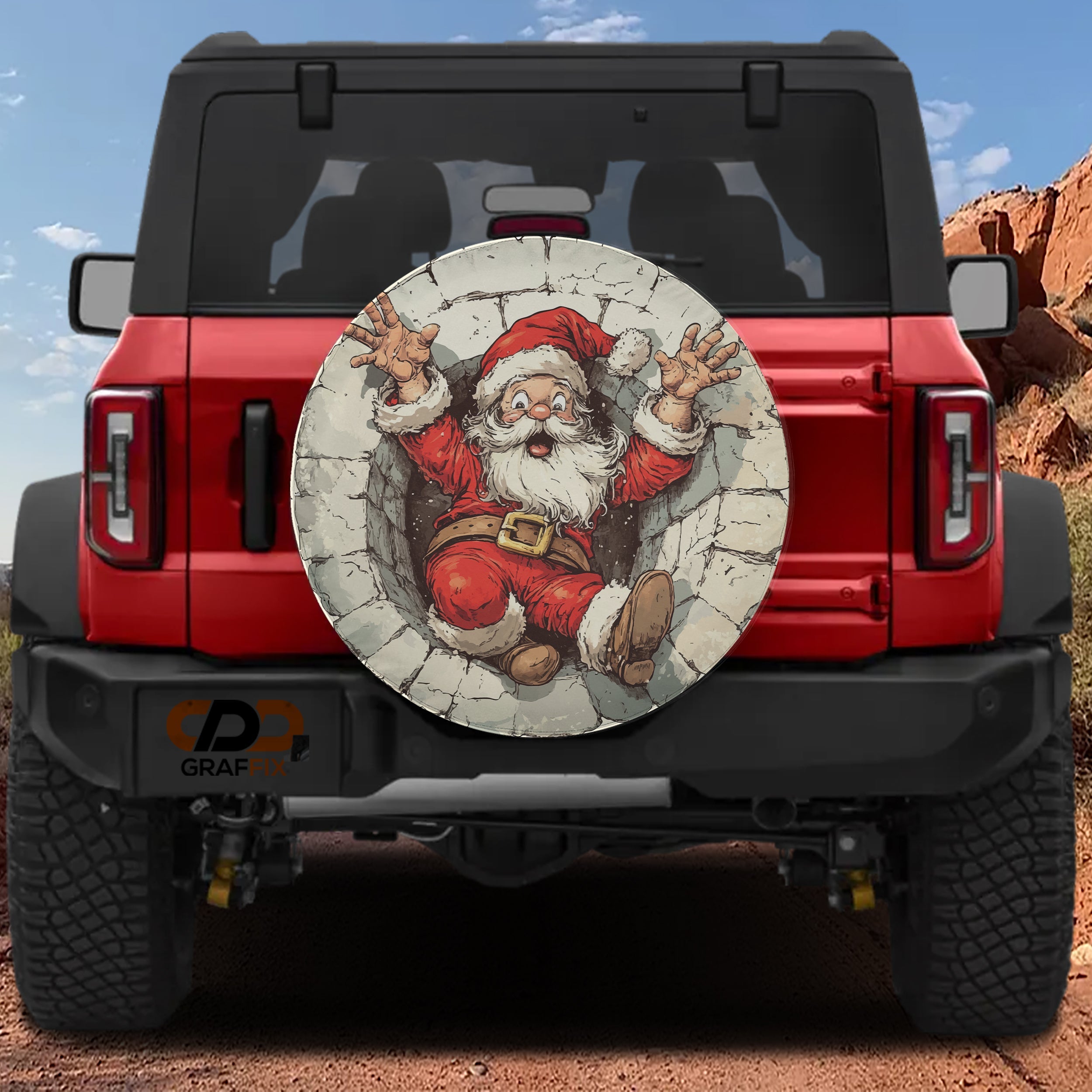 Santa's Great Chimney Escape spare tire cover on a red Jeep Wrangler showing the cartoon Santa stuck in a chimney