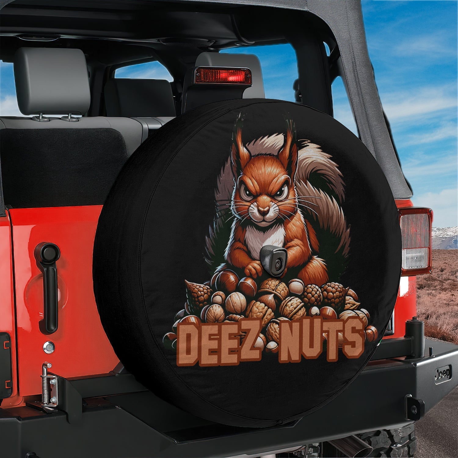 Squirrel deeze nuts tire cover on a red Jeep Wrangler with humorous orange squirrel and nut pile artwork