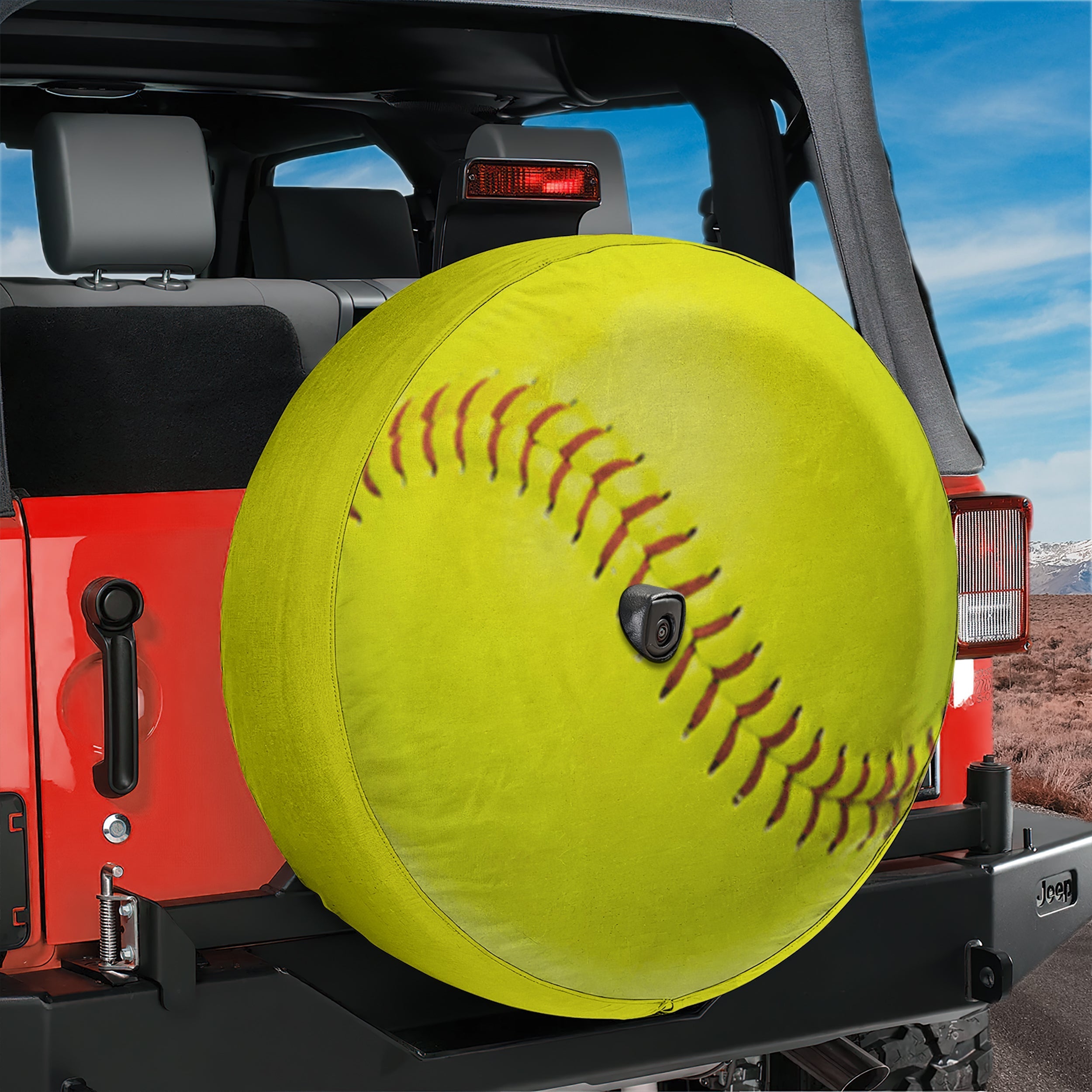 Yellow softball spare tire cover on red Bronco rear with realistic yellow softball graphic