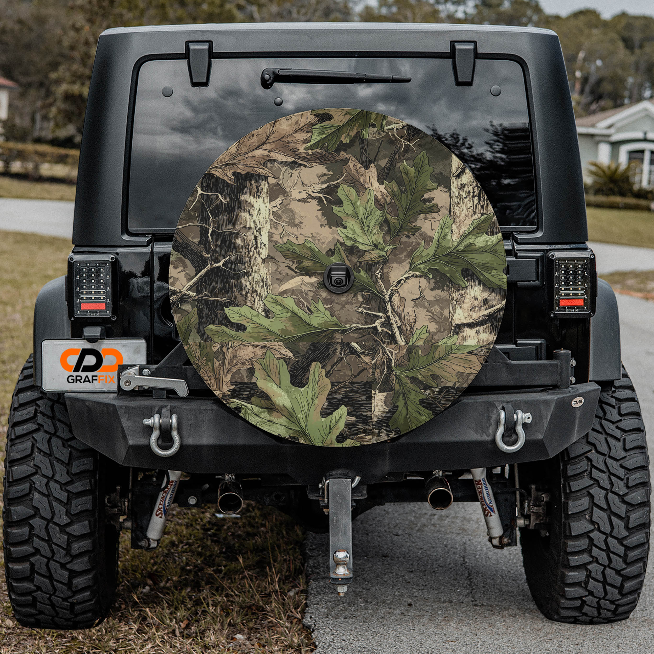 the rear of a black Jeep Wrangler with a camouflage-patterned spare tire attached to the vehicle.